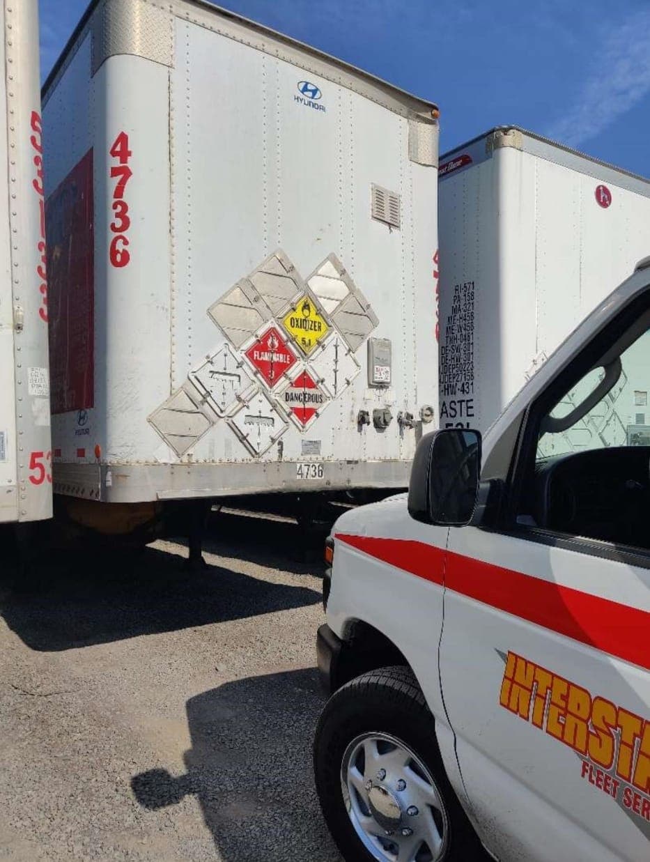 Interstate Fleet Services truck working alongside a trailer on the road